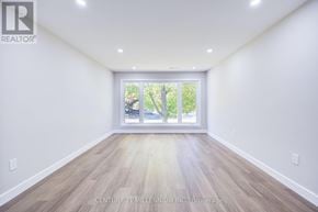 Brampton (Downtown Brampton) fourplex for rent - A spacious room with Century 21 Millennium Inc. Brokerage watermark.