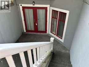 Vancouver apartment for rent - A balcony with a red door and a white railing.