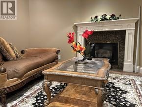 Vancouver apartment for rent - A brown sofa with a glass top coffee table in front of a fireplace.