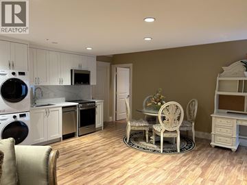 Vancouver apartment for rent - A kitchen with a table and chairs in the middle of the room.