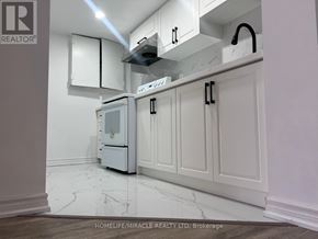 Toronto (Ionview) apartment for rent - A kitchen with white cabinets and a white fridge.