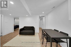 Mississauga (Lisgar) apartment for rent - A living room with a black couch and a dining table.