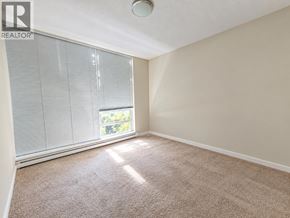 Coquitlam apartment for rent - A room with a carpeted floor and a window with blinds.