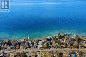 Alderville First Nation apartment for rent - A bird's eye view of a residential area with houses and a body of water.