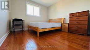 Richmond Hill (South Richvale) apartment for rent - A bedroom with a bed, dresser, and chair.