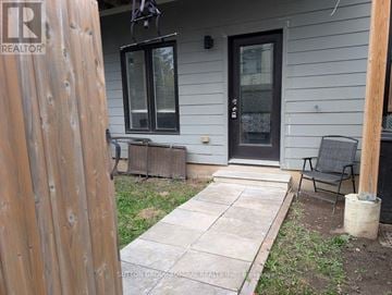 Barrie (Holly) townhouse for rent - A house with a black door and a wooden fence.
