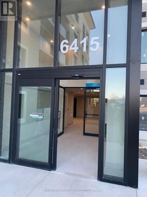 Milton (Wi Willmott) condo for rent - The entrance to a building with glass doors and a number 6415 on the window.