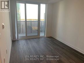 Toronto (Waterfront Communities) condo for rent - A room with a sliding glass door leading to a balcony.