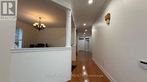 Markham (Thornlea) apartment for rent - A hallway with a chandelier and a white wall.
