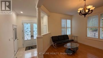 Markham (Thornlea) apartment for rent - A living room with a glass table and a sofa.
