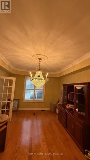 Markham (Thornlea) apartment for rent - A chandelier hangs from the ceiling in a room with wooden floors.