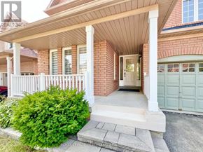 Vaughan (Vellore Village) apartment for rent - A house with a white fence and a green bush in front.