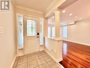 Vaughan (Vellore Village) apartment for rent - A white door with a glass window is in a room with wooden floors.