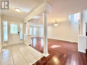Vaughan (Vellore Village) apartment for rent - A spacious room with wooden floors and white columns.