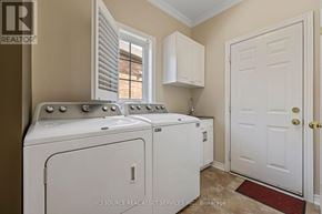Oakville (Wm Westmount) apartment for rent - A white washer and dryer in a laundry room.