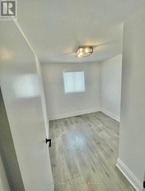 Brampton (Brampton West) apartment for rent - A room with a window and a wooden floor.