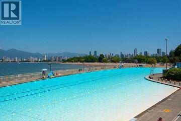 Vancouver apartment for rent - A large swimming pool with a view of the city in the background.