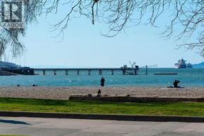 Vancouver apartment for rent - A beach scene with a pier and a ship in the distance.