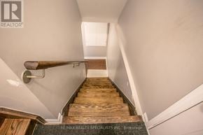 Brampton (Northwest Brampton) apartment for rent - A staircase with wooden steps and a metal handrail.