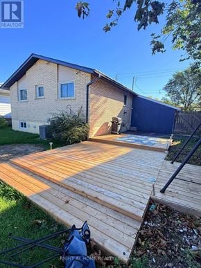 Hamilton (Mountview) apartment for rent - A wooden deck leads to a garage in a residential backyard.