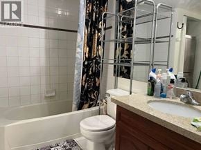 Vancouver apartment for rent - A bathroom with a white toilet, a white sink, and a white bathtub.