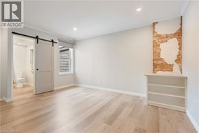 Hamilton townhouse for rent - A room with a sliding door and a wooden floor.