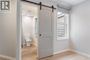 Hamilton townhouse for rent - A white door is open to a bathroom with a toilet and a window.