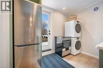 Hamilton townhouse for rent - A kitchen with a stainless steel refrigerator and a white dishwasher and washing machine.