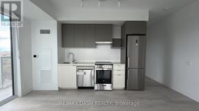 Vaughan (Steeles West Industrial) condo for rent - A modern kitchen with stainless steel appliances and white cabinetry.