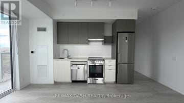 Vaughan (Steeles West Industrial) condo for rent - A modern kitchen with stainless steel appliances and white cabinetry.