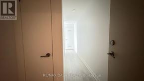 Vaughan (Steeles West Industrial) condo for rent - A hallway with a door on the left and another door on the right.