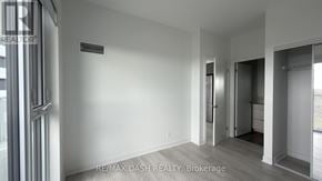 Vaughan (Steeles West Industrial) condo for rent - A room with a door and a window with a sign RE/MAX DASH REALTY, Brokerage.