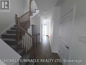 Ottawa apartment for rent - A hallway with a staircase and a door on the right.