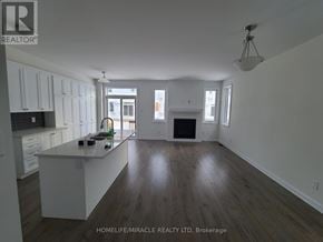 Ottawa apartment for rent - A spacious kitchen and living room with white cabinets and a dark wood floor.