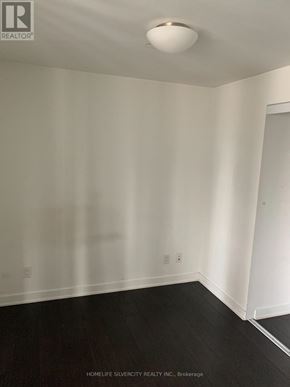 Toronto (Regent Park) condo for rent - A room with white walls and black flooring.