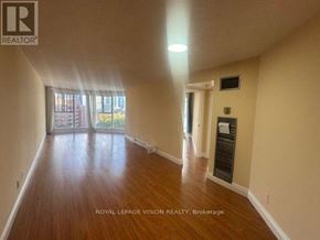 Toronto (Waterfront Communities) condo for rent - A spacious room with wooden floors and a sliding glass door leading to a balcony.