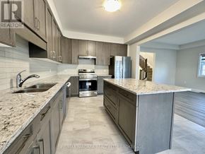 Pelham (Fonthill) townhouse for rent - A kitchen with granite countertops and stainless steel appliances.