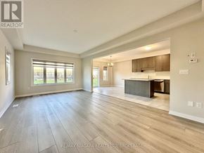 Pelham (Fonthill) townhouse for rent - A spacious living room with a kitchen area in the background.