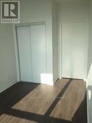 Toronto (Niagara) condo for rent - A hallway with a Realty logo on the bottom left.