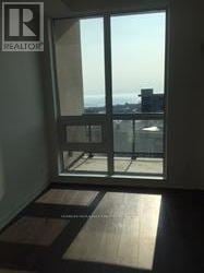 Toronto (Niagara) condo for rent - A window with a view of the cityscape outside.