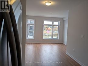 Toronto (Bendale) townhouse for rent - A room with a window showing autumn trees outside.