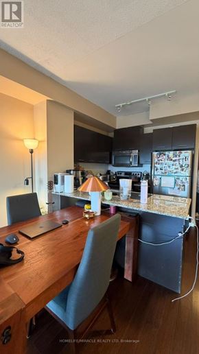 Mississauga (City Centre) condo for rent - A kitchen with a refrigerator, microwave, and oven.