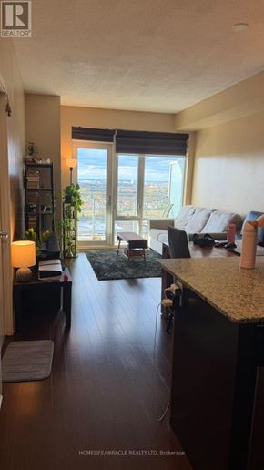 Mississauga (City Centre) condo for rent - A living room with a view of the city through the window.
