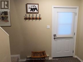 Collingwood townhouse for rent - A white door is in a room with a framed picture of a moose and a shelf with beer taps.