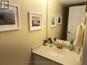 Collingwood townhouse for rent - A bathroom with a sink, mirror, and three pictures on the wall.