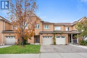 Brampton (Sandringham-Wellington) townhouse for rent - A large, two-story brick house with a tree in front.