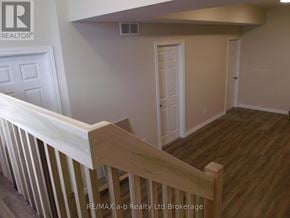 Woodstock (Woodstock - North) apartment for rent - A room with a white door and a wooden staircase.