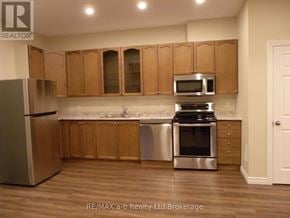 Woodstock (Woodstock - North) apartment for rent - A kitchen with wooden cabinets and stainless steel appliances.
