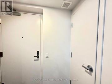 Ottawa condo for rent - A white door with a black handle and a small black dot on the wall.