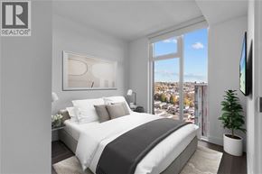 Vancouver apartment for rent - A bedroom with a large bed and a view of the city.